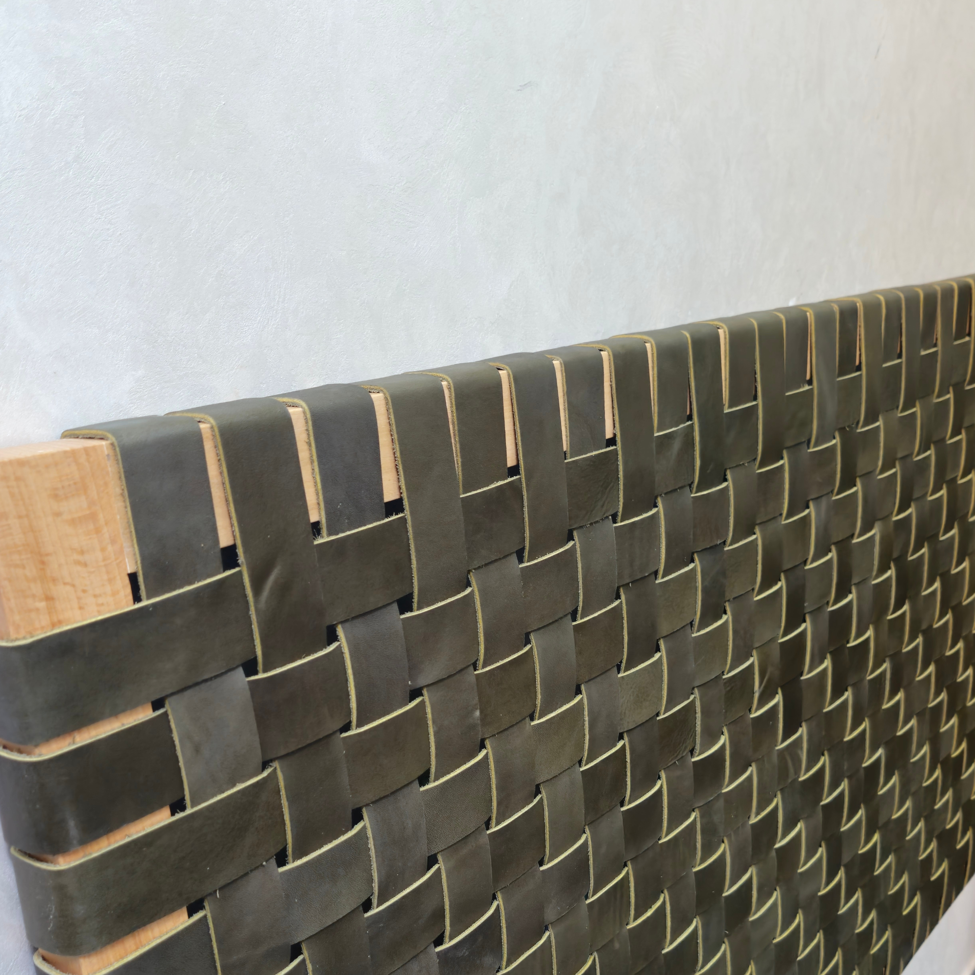 Woven leather headboard with wooden frame on a white background