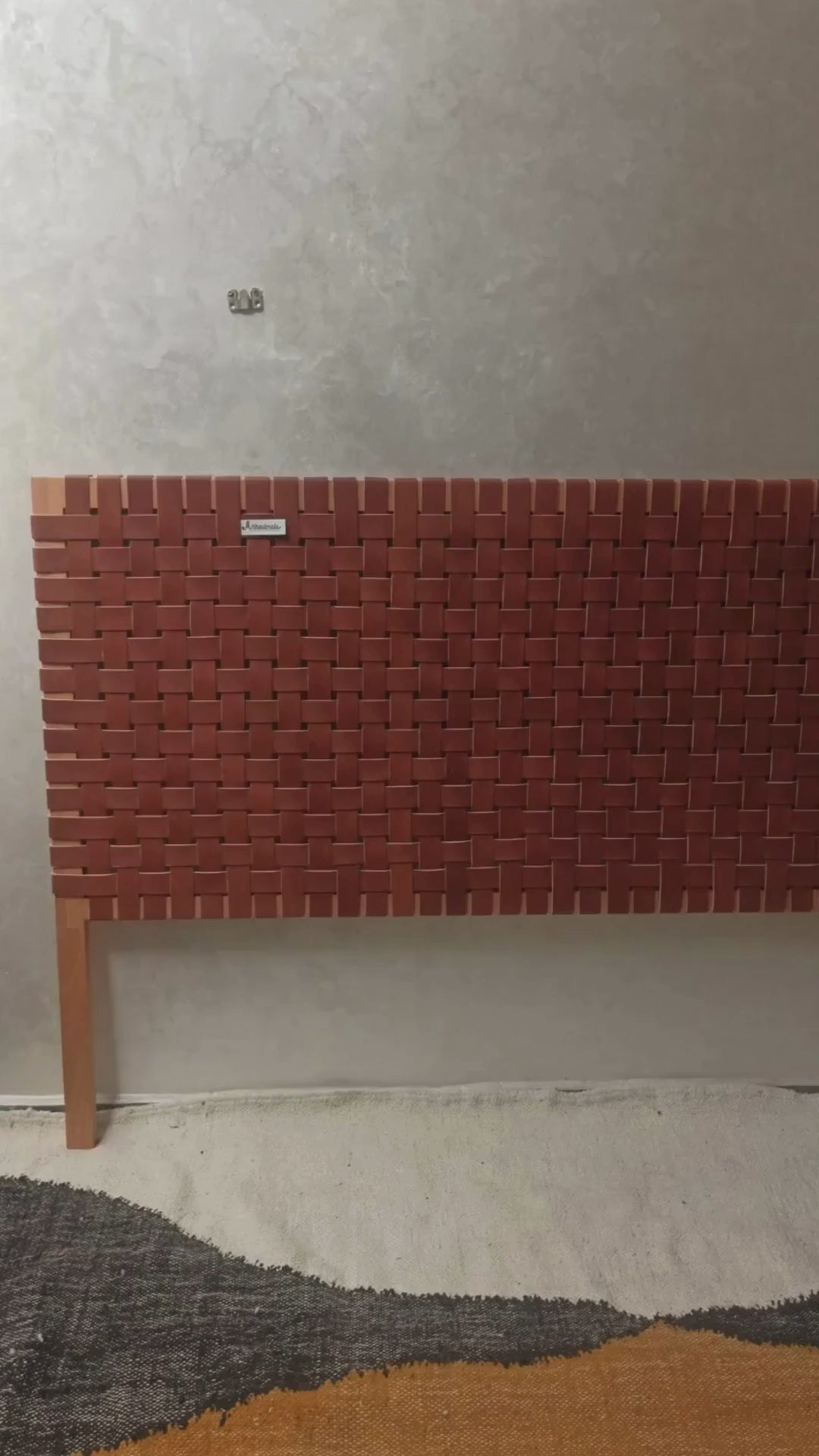 Detail of Artihandmade® full grain leather headboard, showcasing hand-tooled strap texture.