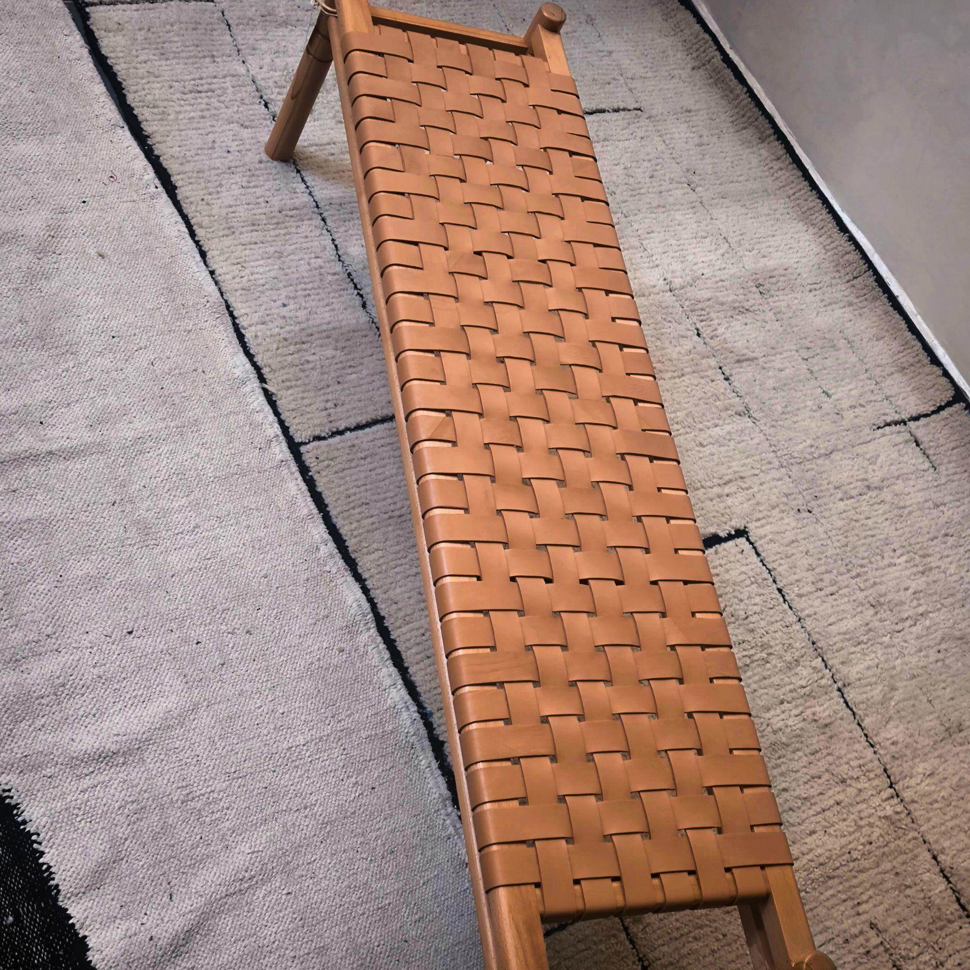 Brown woven bench on a textured stone floor