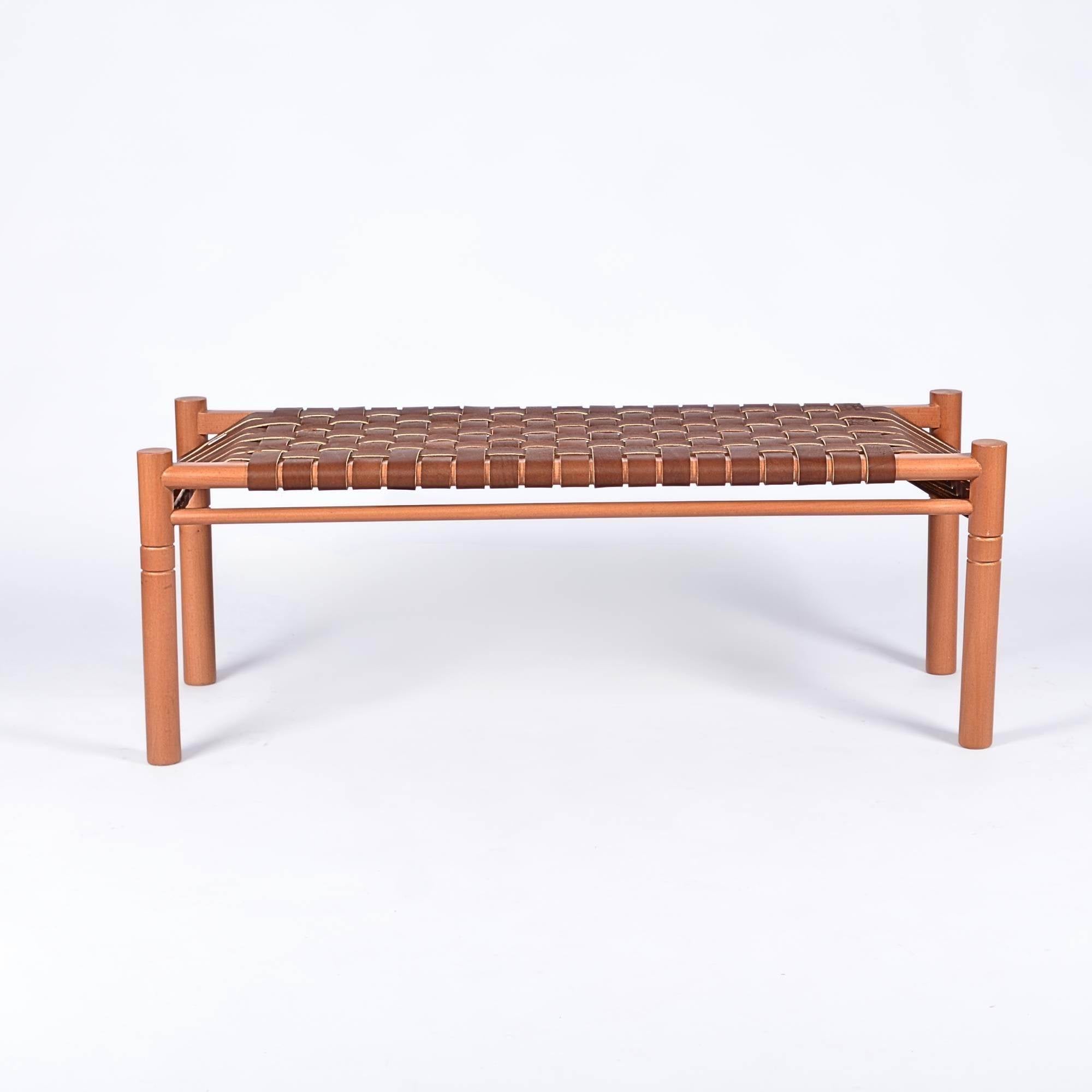 Wooden bench with woven seat on a white background