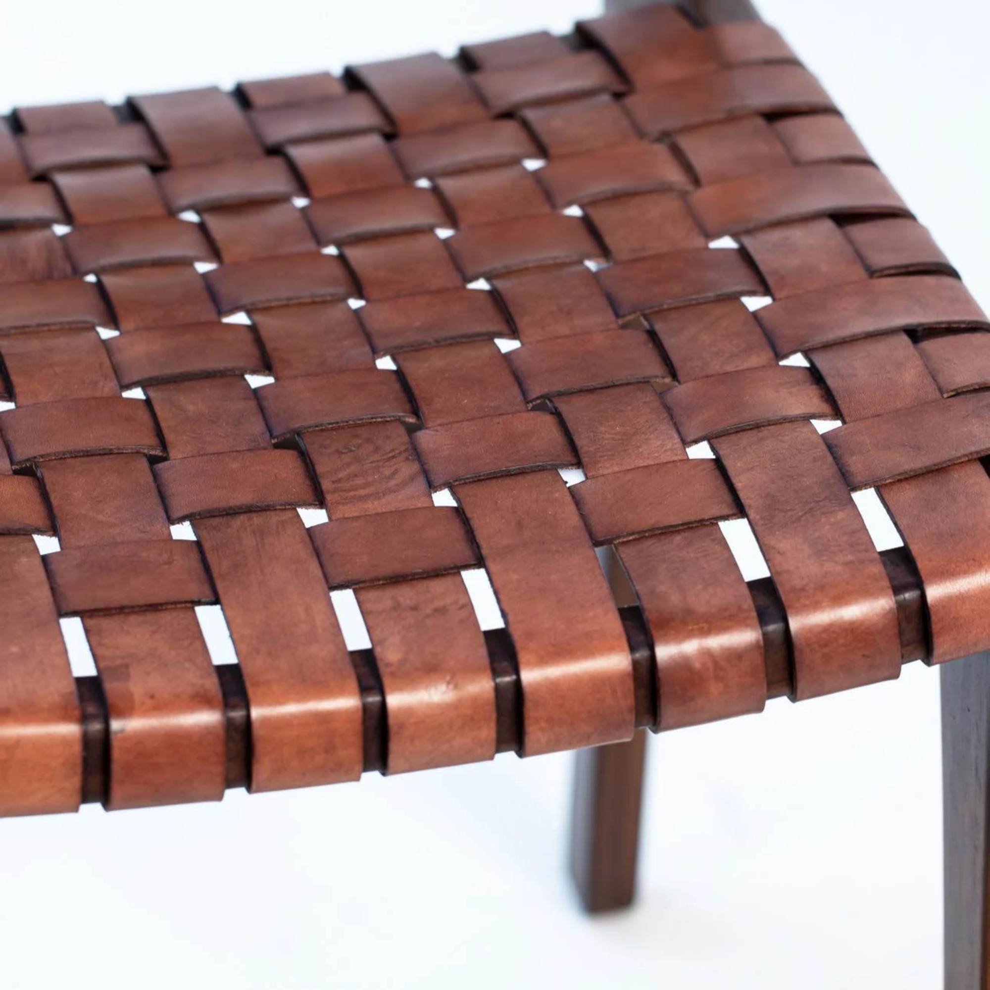 Vegetable-tanned leather seat of Ljus chair developing a rich, unique patina over time.