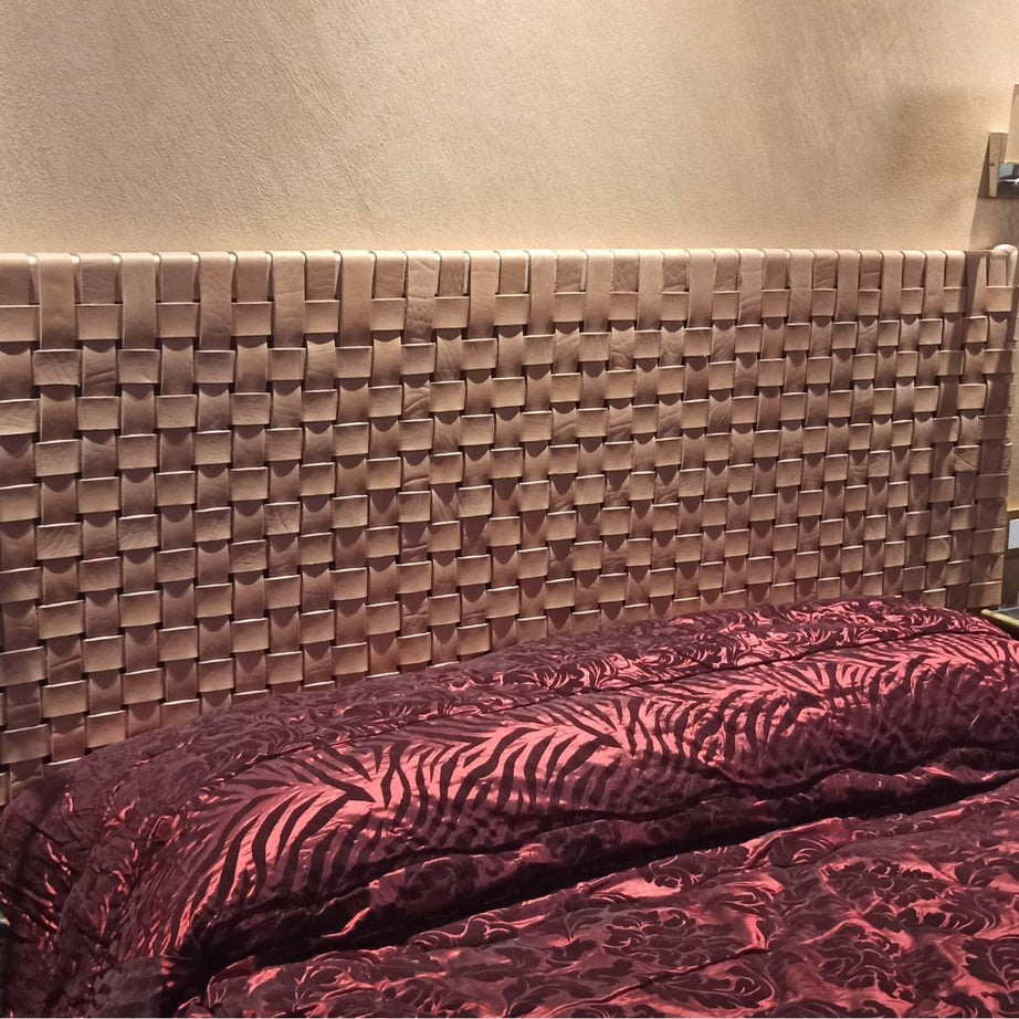 Detailed shot of natural leather texture on a handcrafted woven headboard, featuring unique artisanal weaving patterns